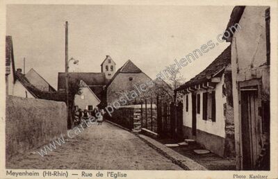 Carte postale ancienne Rue de l'Eglise — Meyenheim (Haut-Rhin)